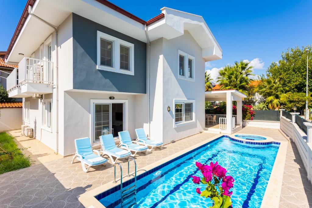 a villa with a swimming pool and a house at Villa Capital in Dalyan