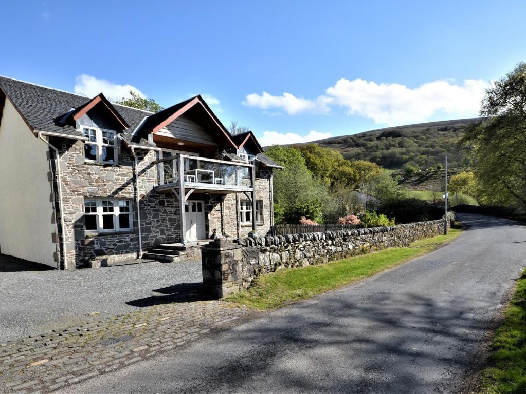 a stone house on the side of a road at 5 bed in Colintraive 74117 in Colintraive