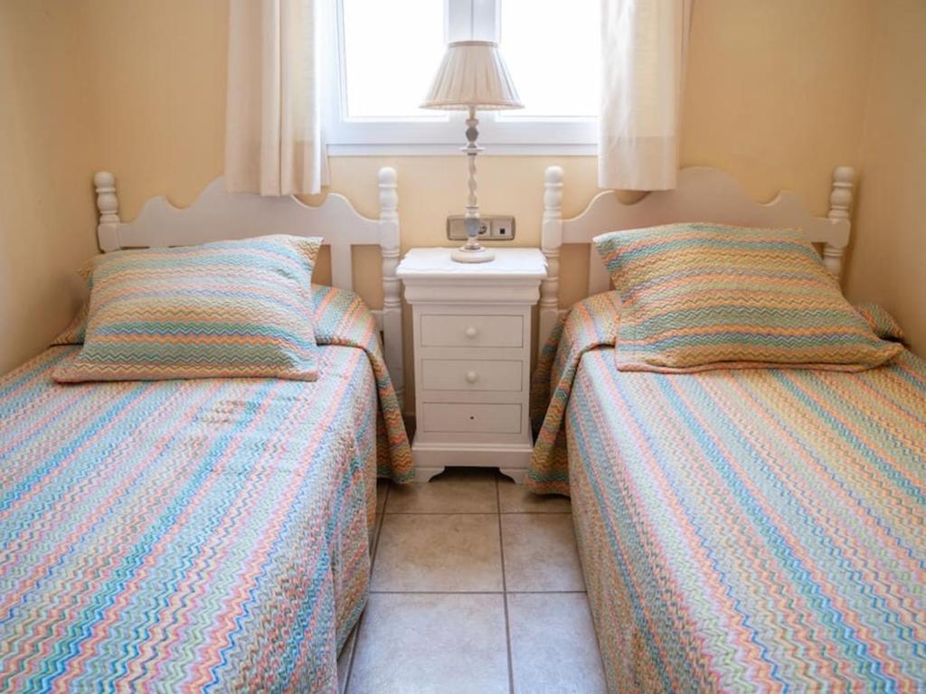 A bed or beds in a room at Holiday Villa Vergel with Huge Private Pool, Jacuzzi, Sauna & BBQ by Amazzzing Travel