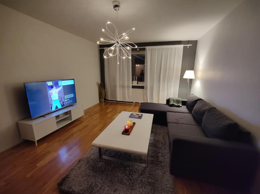 a living room with a couch and a tv at M:Hamn Centrum in Mariehamn