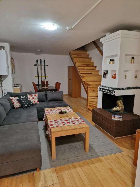 a living room with a couch and a coffee table at BJELAŠNICA BEX APARTMANI in Bjelašnica