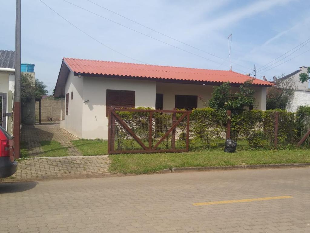 a house with a gate in front of it at Itapeva736 in Torres