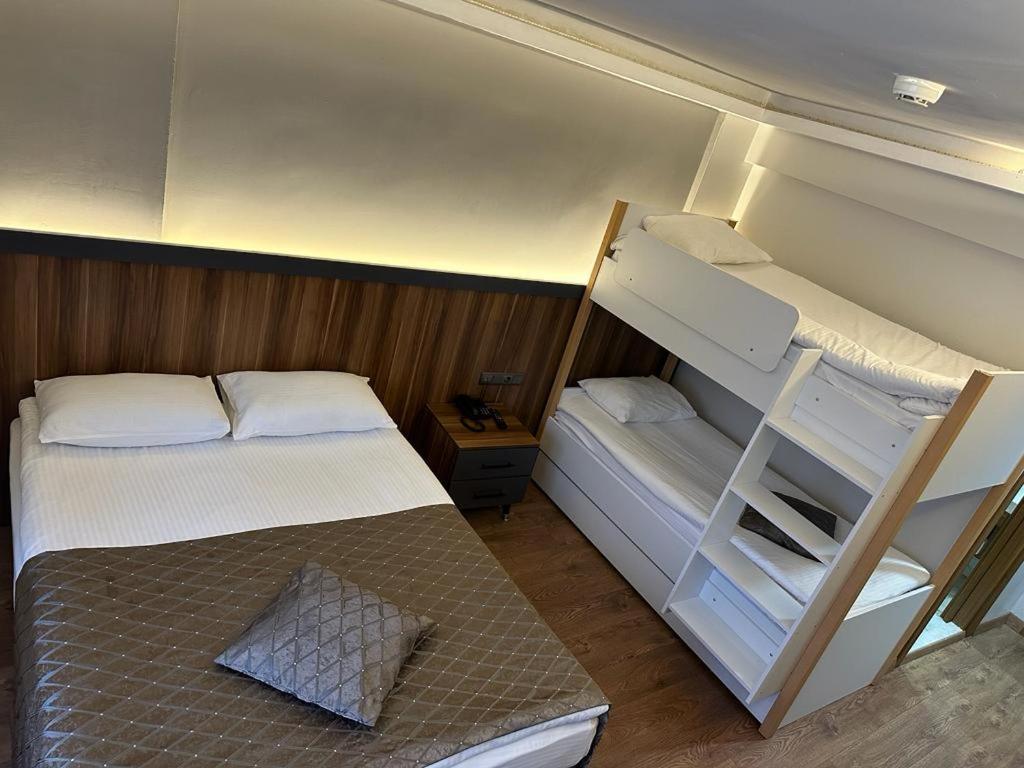 a small bedroom with a bunk bed and a ladder at SAKA LİFE OTEL in Erzurum