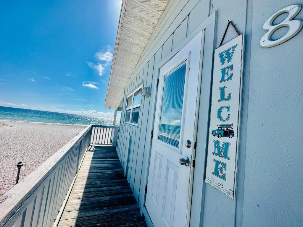 a building on the beach next to the ocean at Beachfront Bungalow in Clearwater Beach