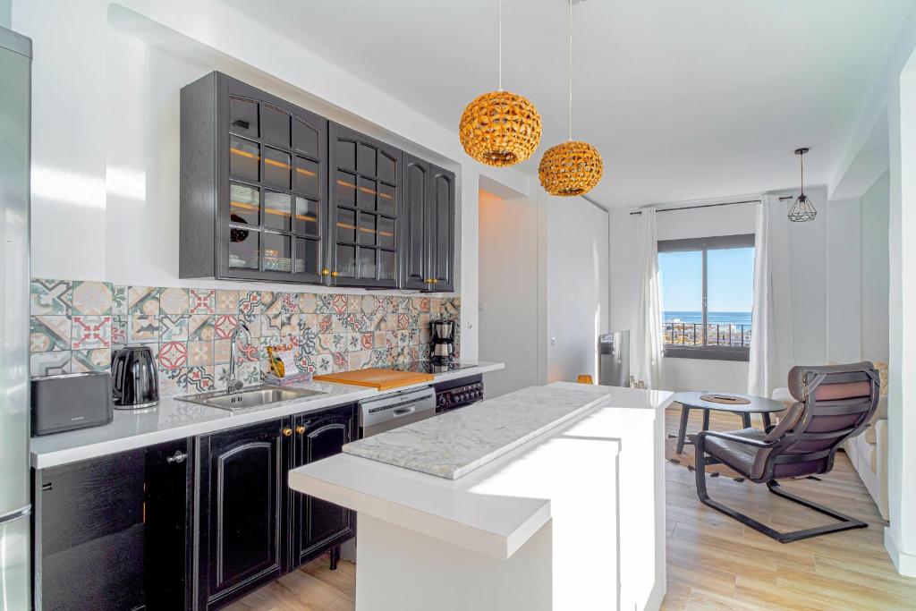 a kitchen with a sink and a counter top at Marina Vista Paradise Casasol in Nerja