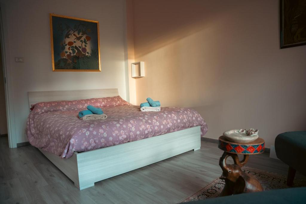 a bedroom with a bed with blue pillows on it at FiordalisoHouse-Stadio Olimpico in Turin