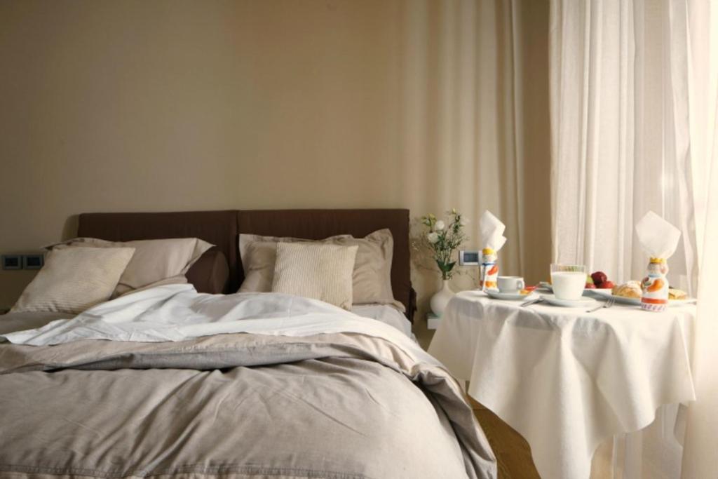 a bedroom with a bed with two tables with drinks at Venere B&B in Catania