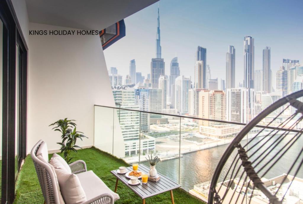 a balcony with a view of the city at binghatti canal , burj Khalifa view with private jacuzzi and cinema screen ,KINGS in Dubai