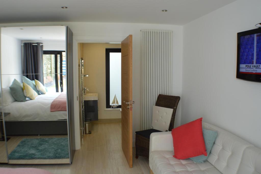 a bedroom with a bed and a mirror at Pier39Portrush Adult Only in Portrush