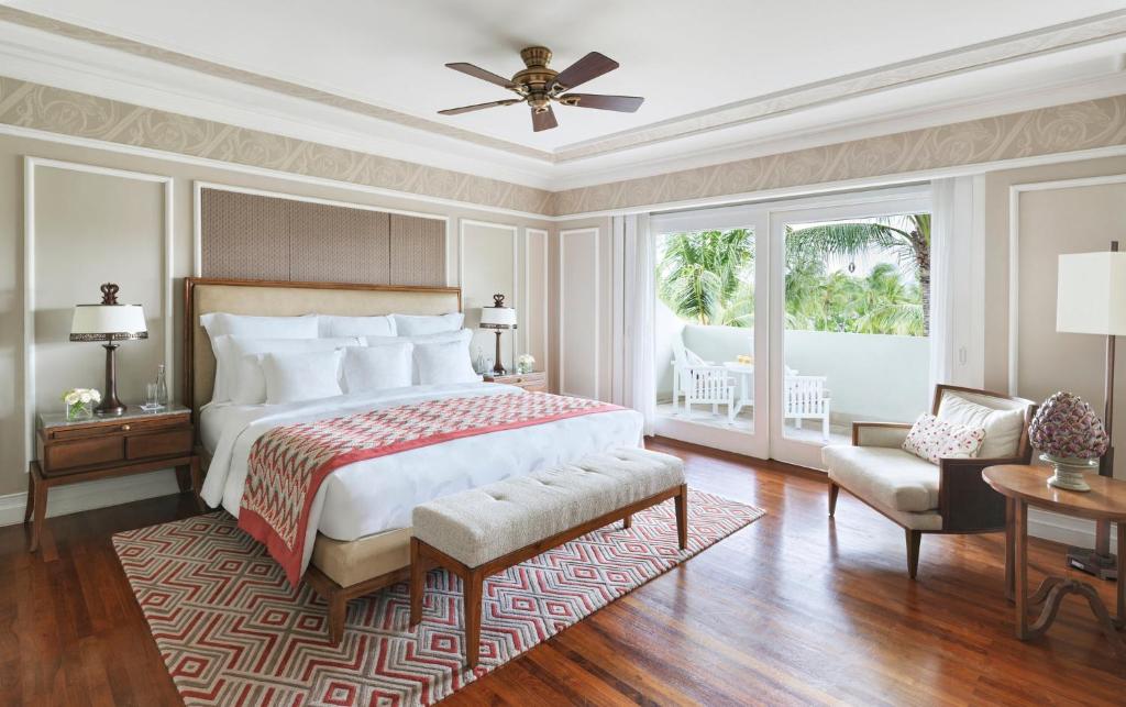 a bedroom with a large bed and a large window at InterContinental Bali Resort by IHG in Jimbaran