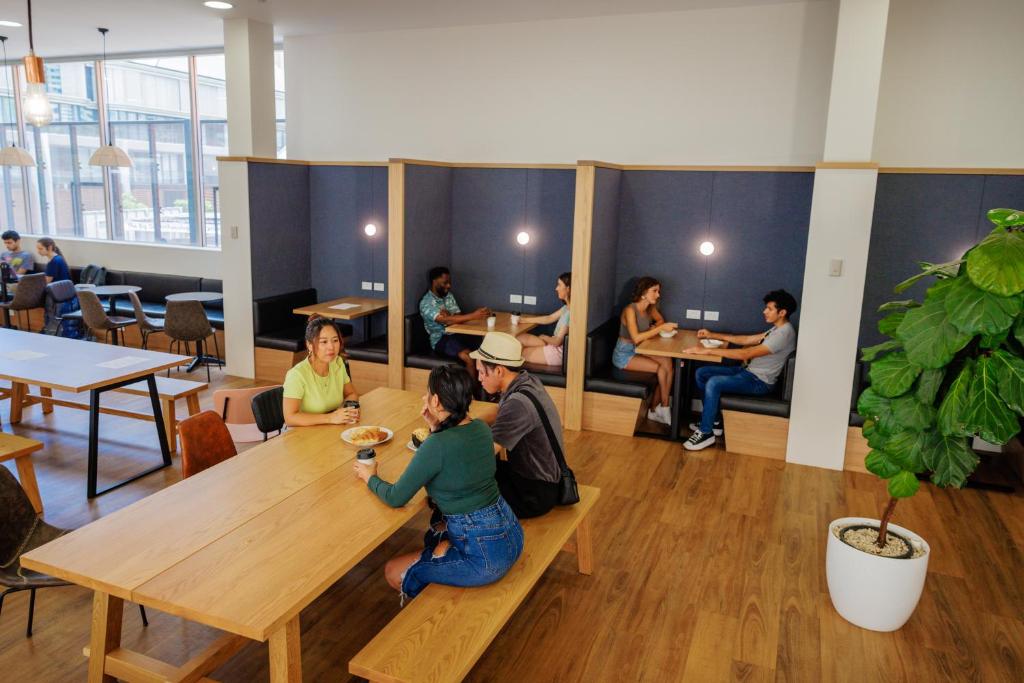 a group of people sitting at a table in a restaurant at YHA Sydney Harbour in Sydney