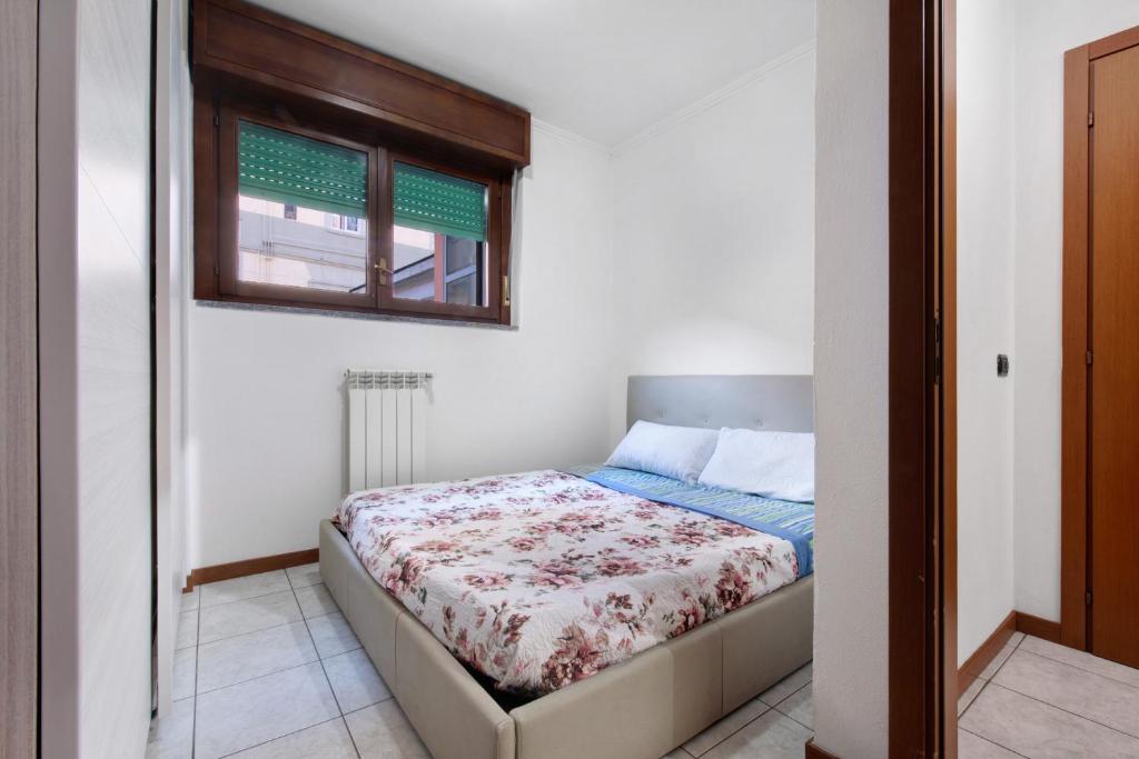 a bed in a room with a window at Dogana Ponte Chiasso G e P 2 in Como