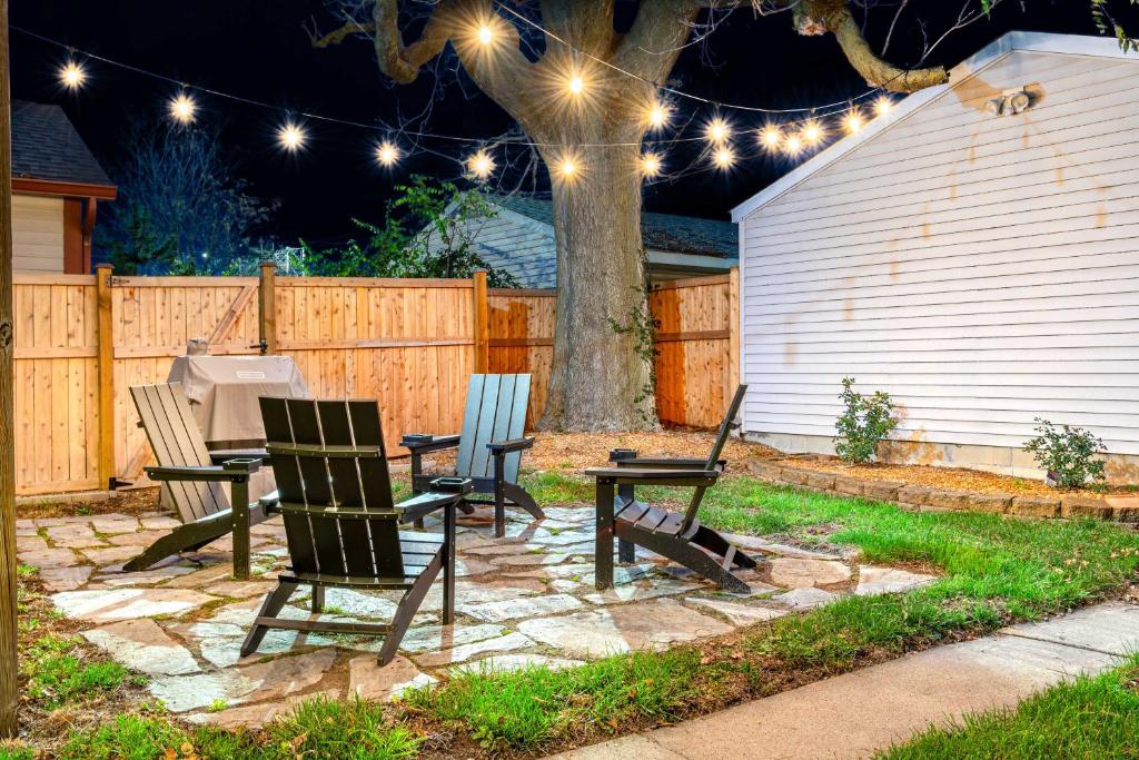 a patio with three chairs and a table with lights at Chic Indianapolis Home with Patio Less Than 2 Mi to Downtown in Indianapolis