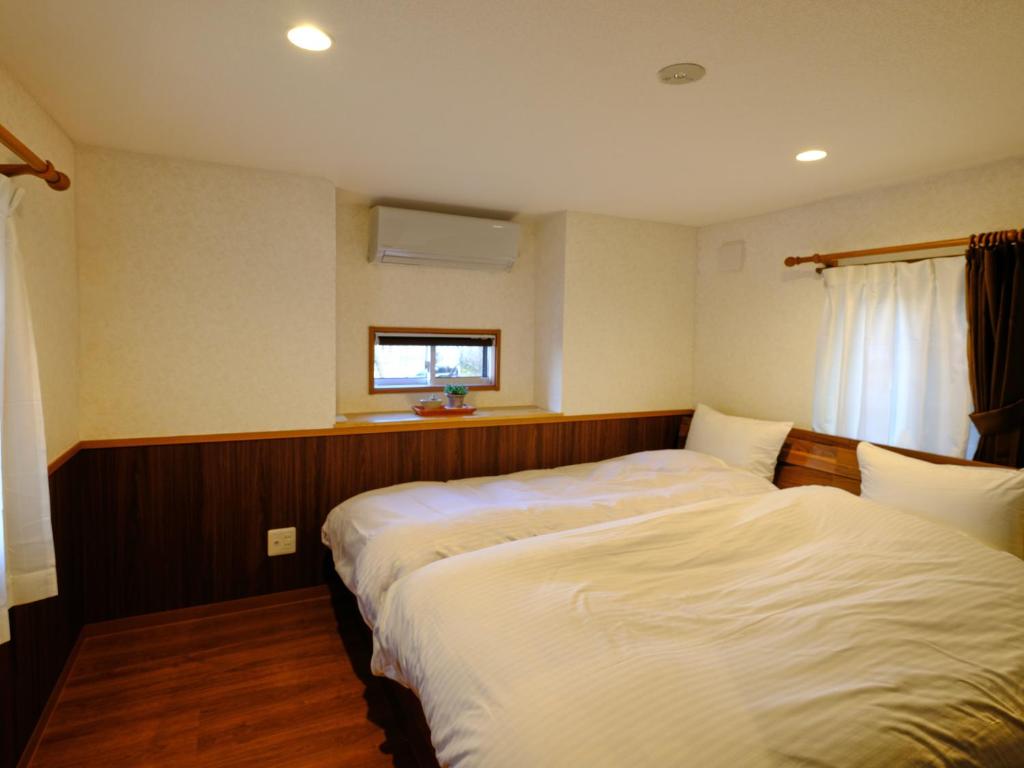 Postel nebo postele na pokoji v ubytování Hotel Soyokaze
