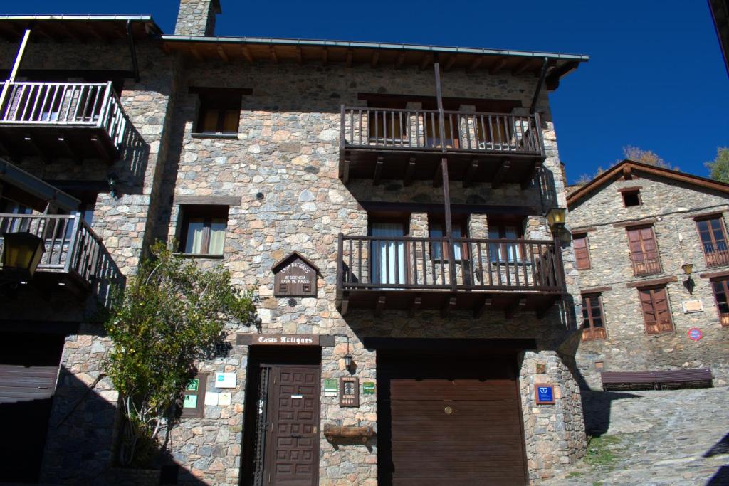 an old stone building with balconies and a door at Cases Artigues in Os de Civís