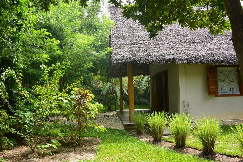 a small house with a grass roof at Coco Komba Lodge in Nosy Komba
