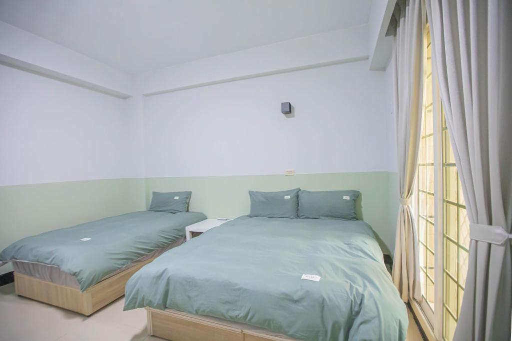 Postel nebo postele na pokoji v ubytování 卡薩行旅貳館 包棟民宿