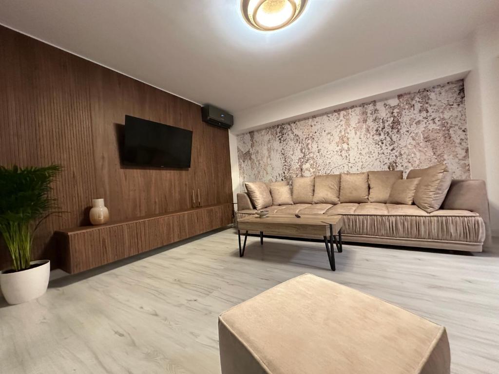 a living room with a couch and a tv at Luxury apartment , Private parking, Self Check-in64 in Craiova