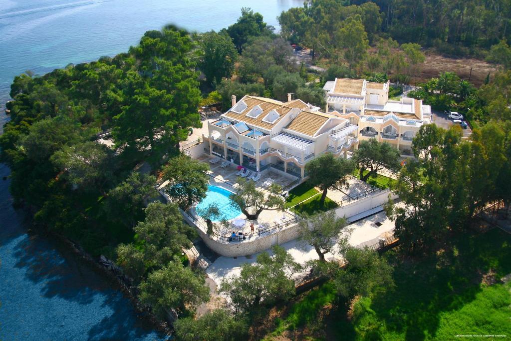 an aerial view of a mansion with a swimming pool at Saint Nicholas Beach Resort in Dassia