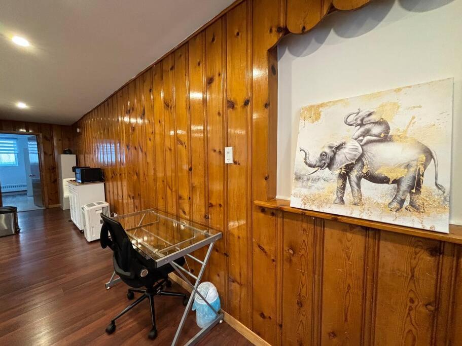 a room with a painting of an elephant on the wall at Cozy Spacious Work Friendly Lotus with Garden View High speed free Wi Fi and Parking Adjacent to Downtown Montreal in Montreal