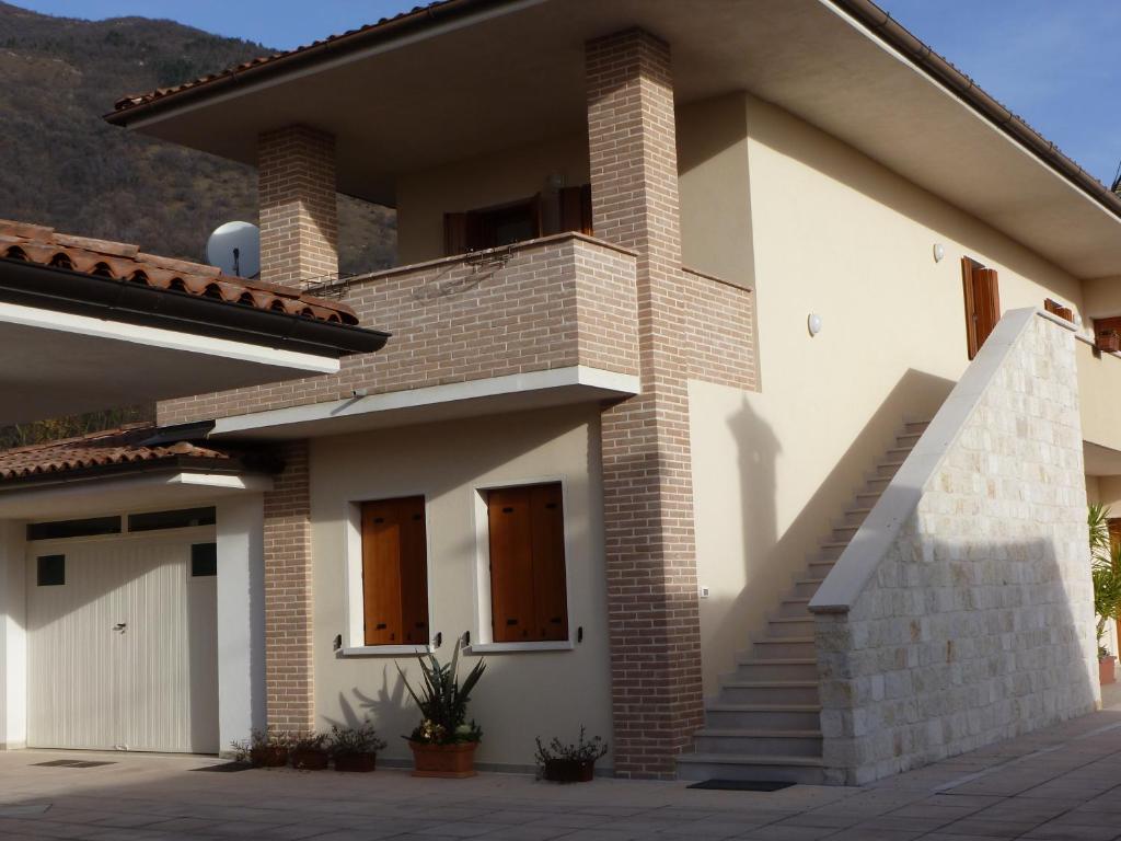 a house with a staircase in front of it at Albergo Diffuso Polcenigo C.Barnard in Polcenigo