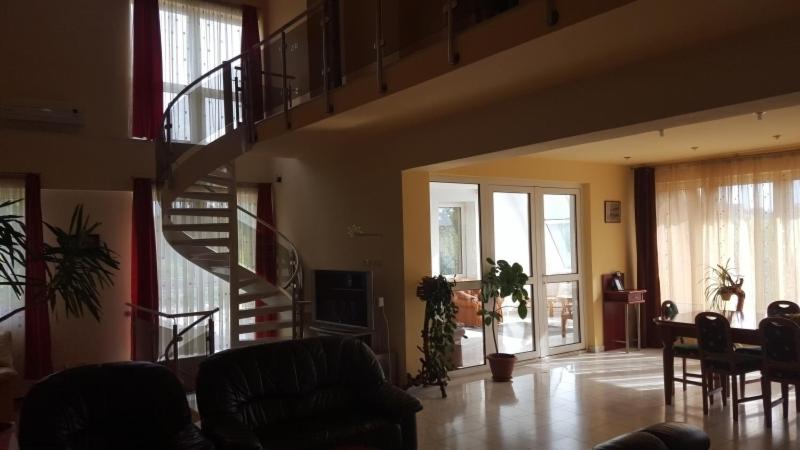 a living room with a spiral staircase in a house at Vila Zorii Zilei in Baile Felix