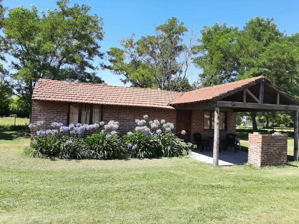 a brick building with a pavilion in a park at Cabañas Sol de las Sierras in Tandil