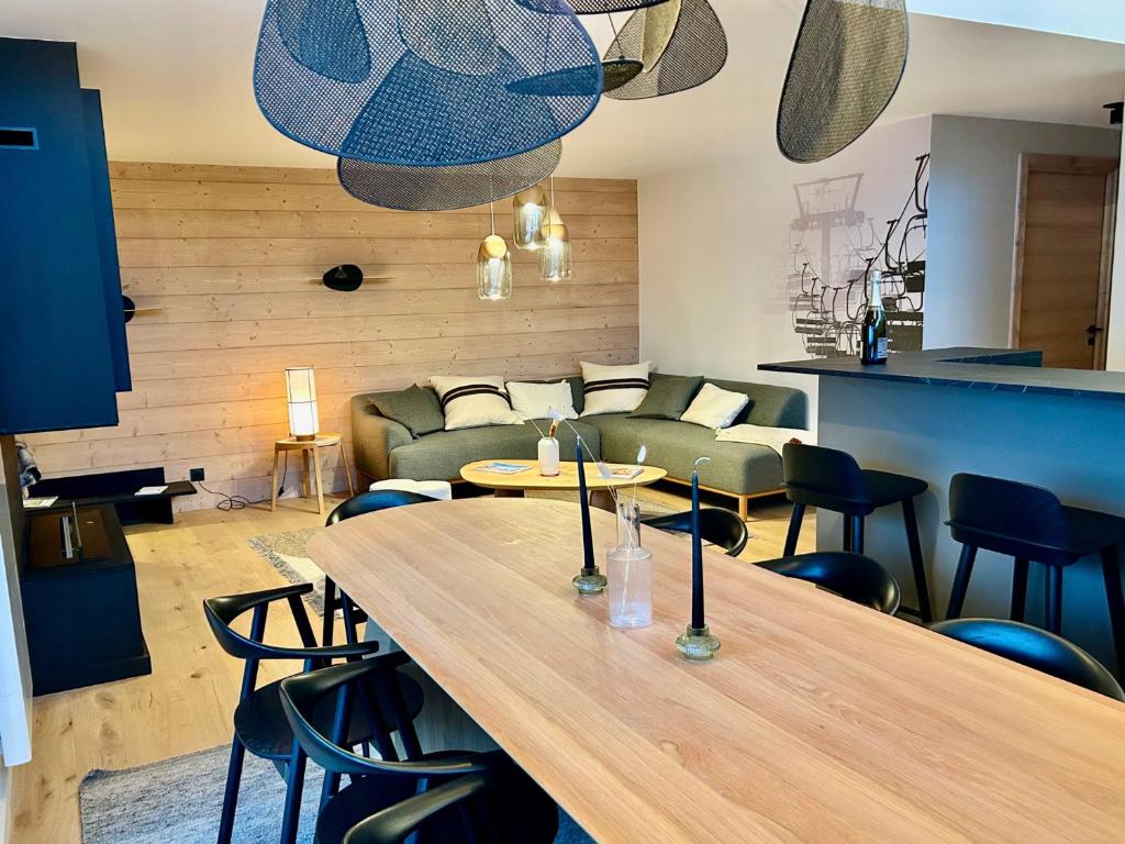 ein Wohnzimmer mit Tisch und Couch in der Unterkunft Appartement neuf à Méribel, proche des pistes, balcon, service concierge inclus! - FR-1-613-103 in Les Allues