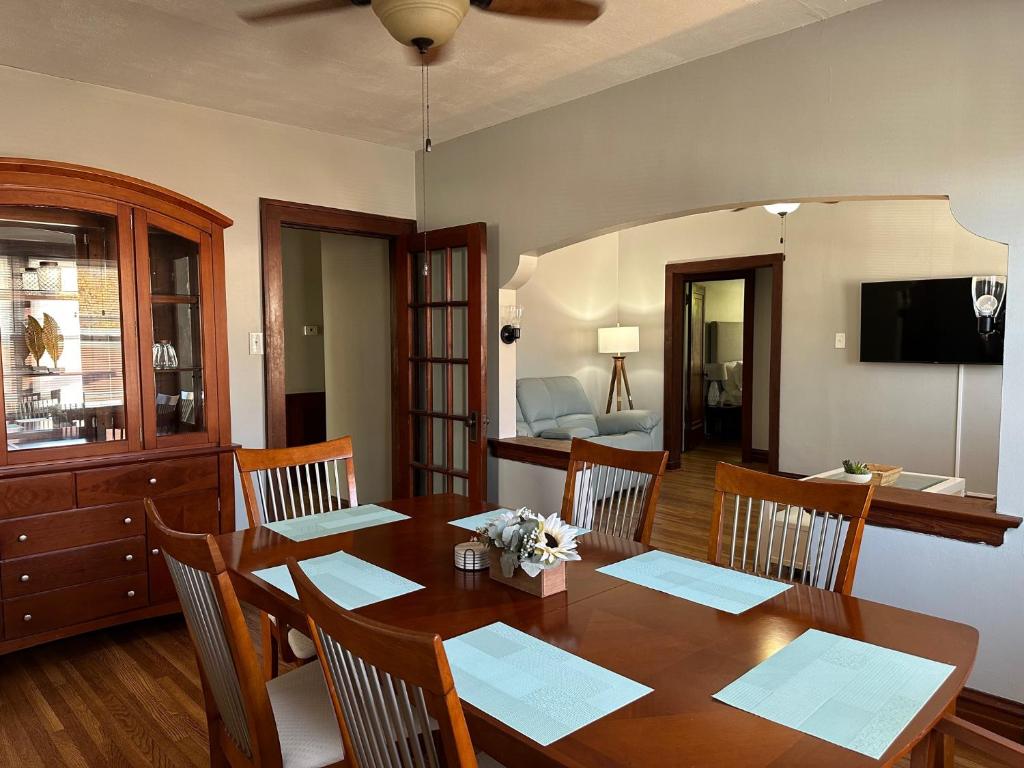 a dining room with a wooden table with chairs at New 3 Bedroom City Escape in Saint Louis