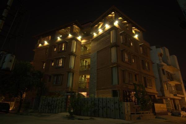 a large building with lights on top of it at night at Nisargha Serviced Apartments in Bangalore