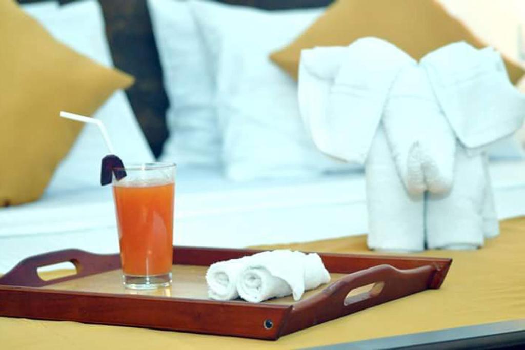 een dienblad met handdoeken en een drankje op een tafel bij Green View Safari Paradise in Udawalawe