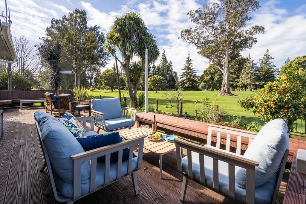 a patio with two couches and a table at Stay and Play in Motueka in Motueka