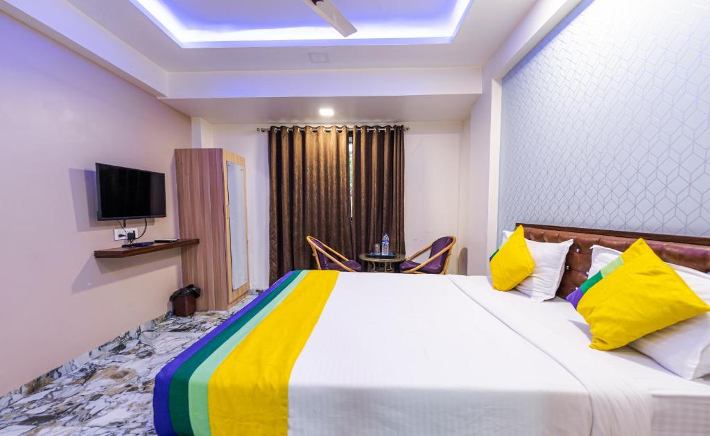 a bedroom with a large bed with a colorful blanket at Itsy By Treebo - Golden Birds in Mumbai