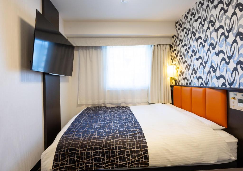 Postel nebo postele na pokoji v ubytování APA Hotel Osaka Umeda