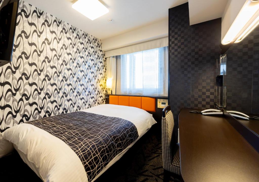 Postel nebo postele na pokoji v ubytování APA Hotel Osaka Umeda