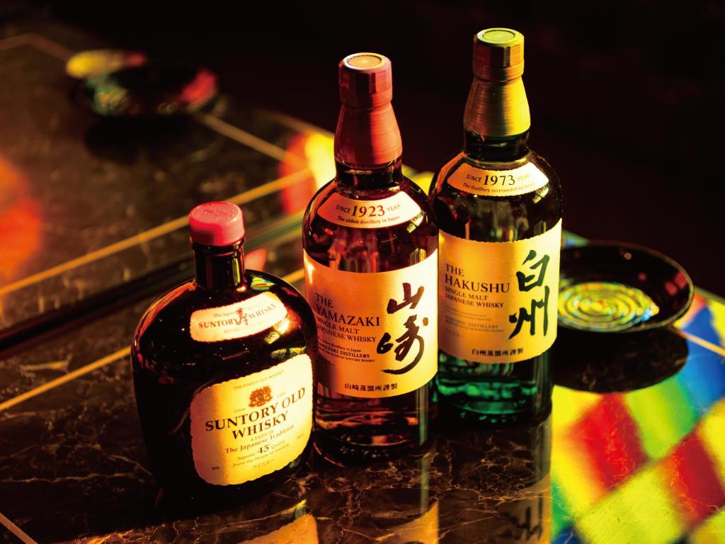 three bottles of wine sitting on a table at Aqua Palace Chatan by Coldio Premium in Chatan