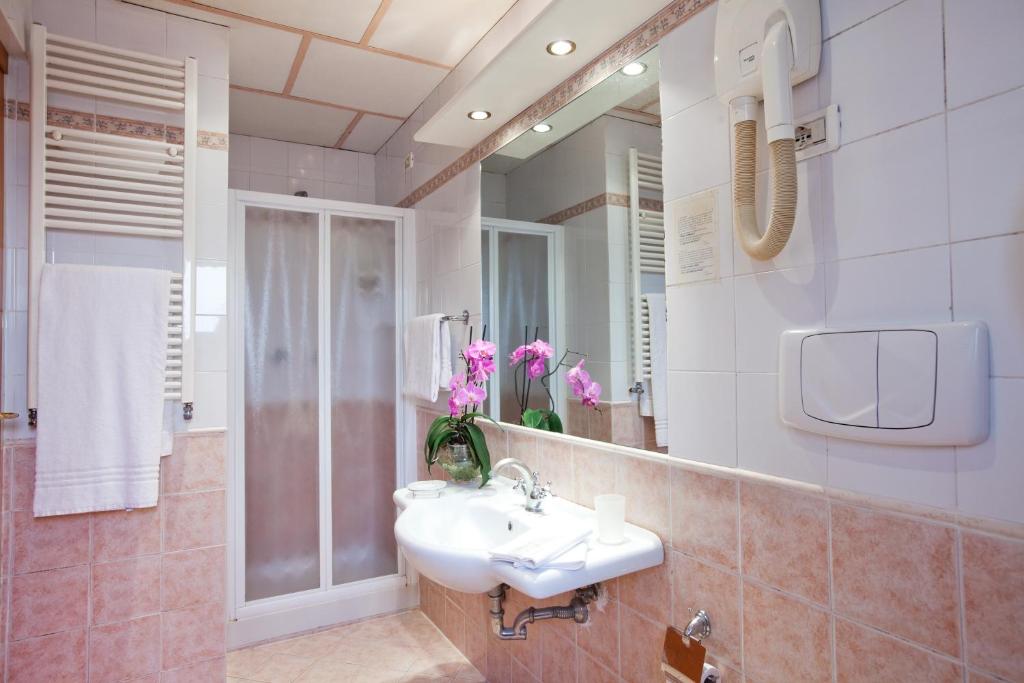 um banheiro com uma pia e um espelho em Hotel Delle Muse em Roma
