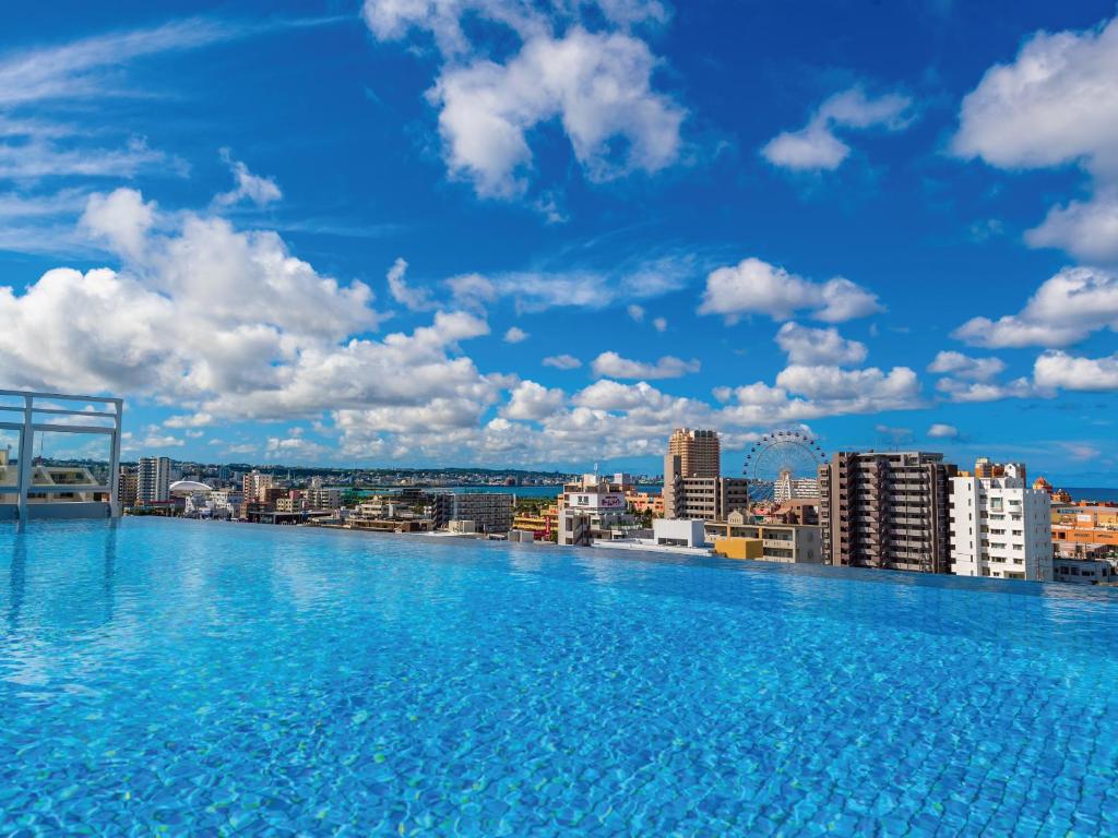 a swimming pool on the roof of a building at Aqua Palace Chatan by Coldio Premium in Chatan