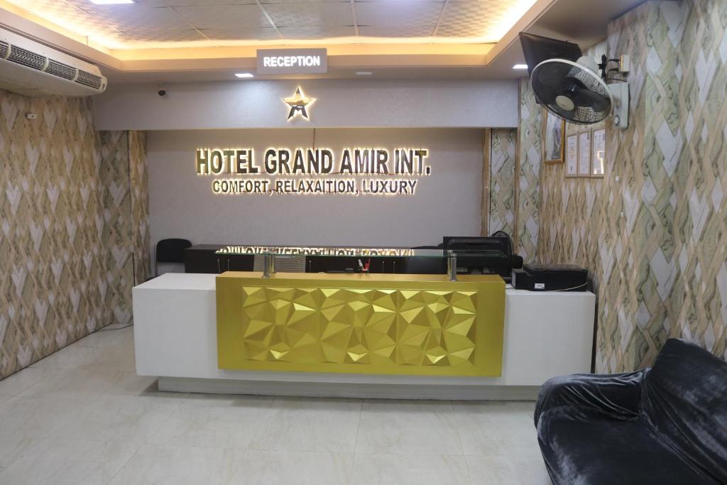 a hotel grand entrance with a reception desk in a room at Hotel Grand Amir International in Dhaka