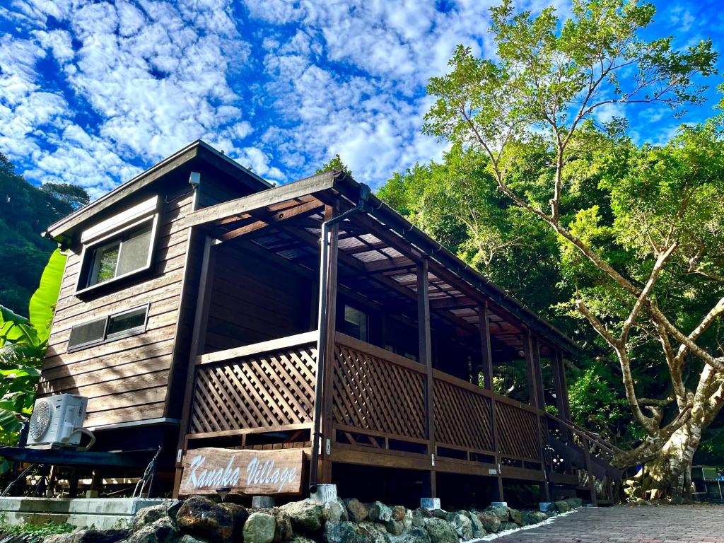 a cabin in the woods with a roof at カナカヴィレッジ in Ogasawara