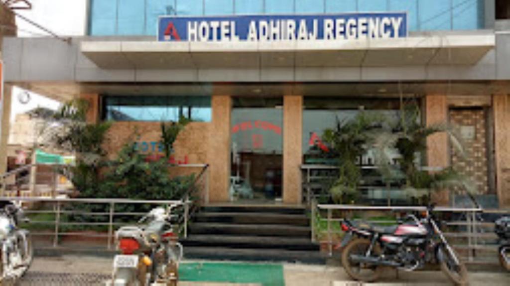 two motorcycles parked in front of a hotelanimalagency at Hotel Adhiraj Regency, Ashoknagar in Ashoknagar