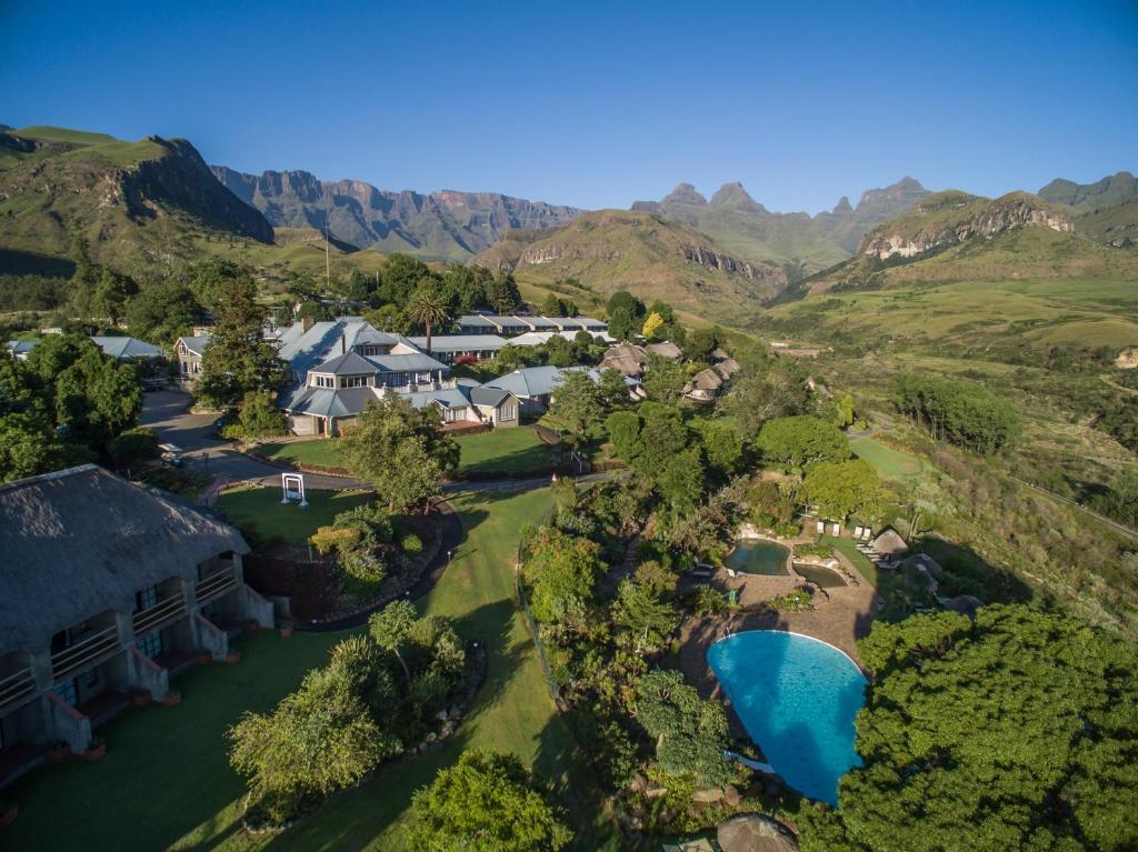 an aerial view of a resort with mountains in the background at Cathedral Peak Hotel in Winterton