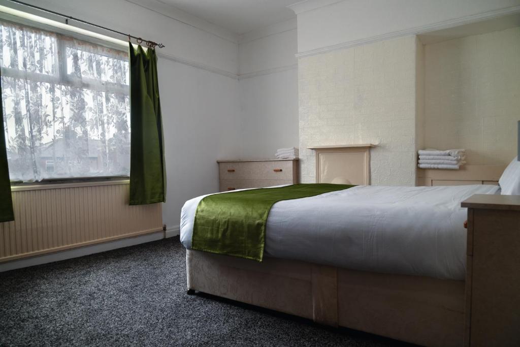 a bedroom with a large bed and a window at Amarillys Guest House in Preston