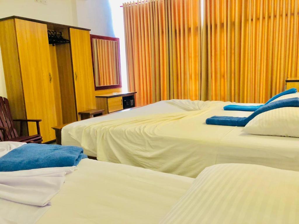 Postel nebo postele na pokoji v ubytování Mirissa Beach Inn
