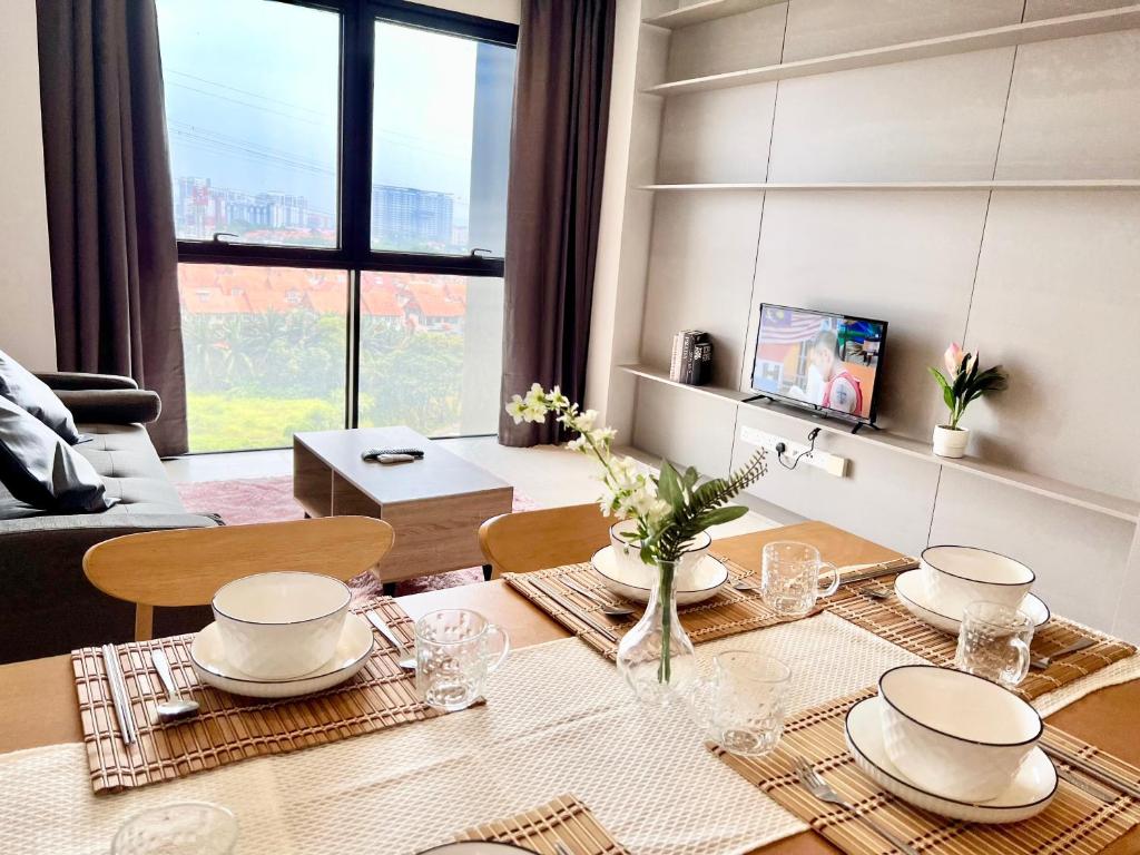 a living room with a dining room table with a table at LB Cozy Home 1-10Pax 3Room Tropicana 4QBeds BalconyTV in Petaling Jaya