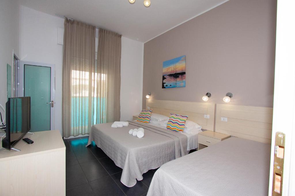 Postel nebo postele na pokoji v ubytování Hotel Spiaggia Marconi