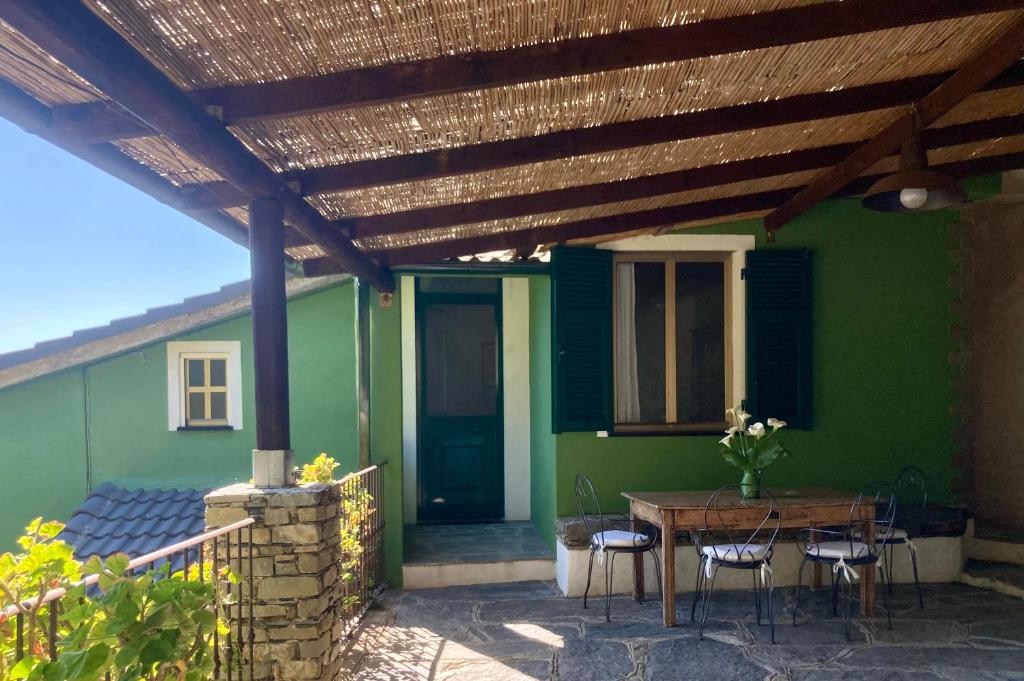 a patio with a table and chairs under a wooden pergola at Villa Pietrafiore in Monterosso al Mare
