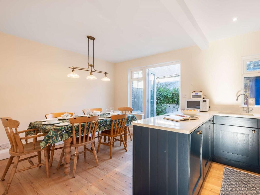 a kitchen and dining room with a table and chairs at 3 Bed in Swanage 84019 in Swanage