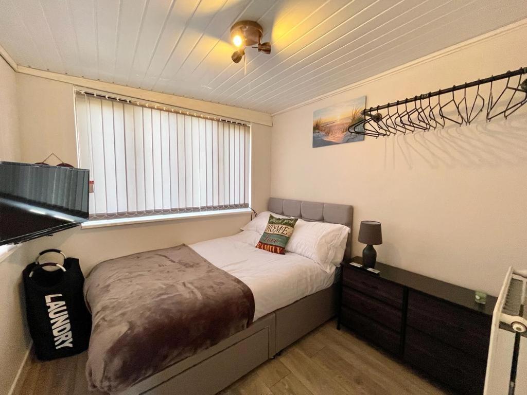 a bedroom with a bed and a window in it at Blakes Beach House Humberston Fitties in Humberston