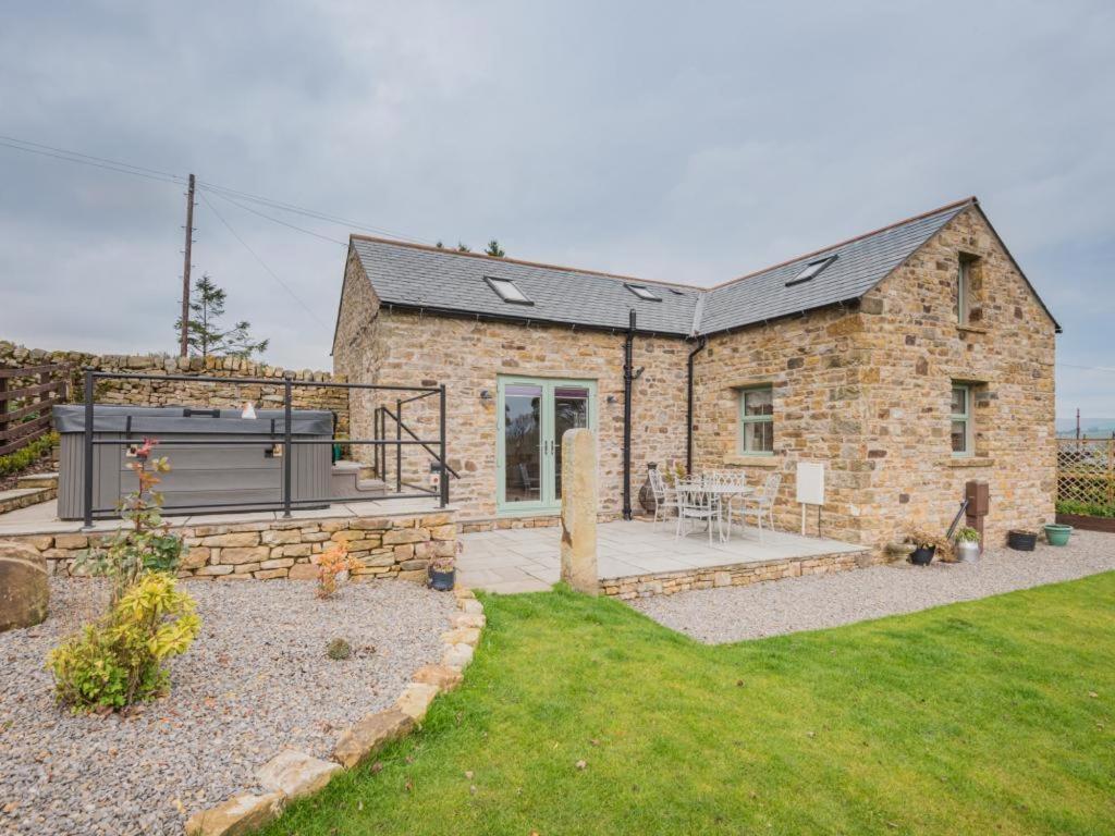 a stone house with a patio in the yard at 2 Bed in Alston SZ186 in Leadgate